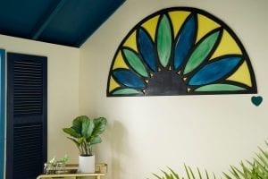 Shed detail: Wall art of a green and blue flower.