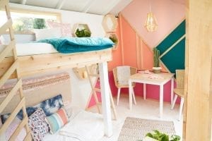 Shed detail: Lofted beds, table, and two chairs.