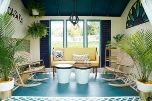 Shed detail: Sitting area with yellow couch and two rocking chairs.