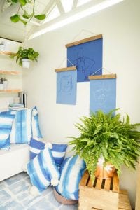 Shed detail: Blue throw pillows and hanging wall art.