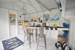Pool shed interior. Table shaped like surf board with food on top.
