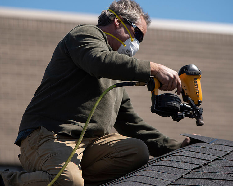 Backyard Products installer adding shingles on pavilion Backyard Products installing pavilion at Beaumont Hospital