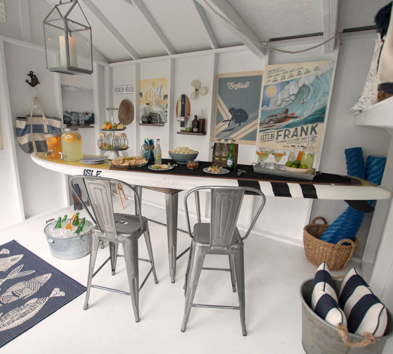 Pool shed interior. Table shaped like surf board with food on top.