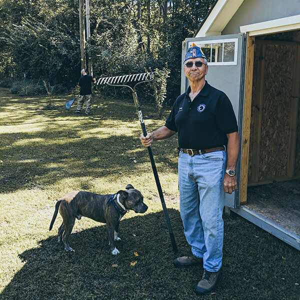 Image of veteran holding rake for gardening gardening storage ideas